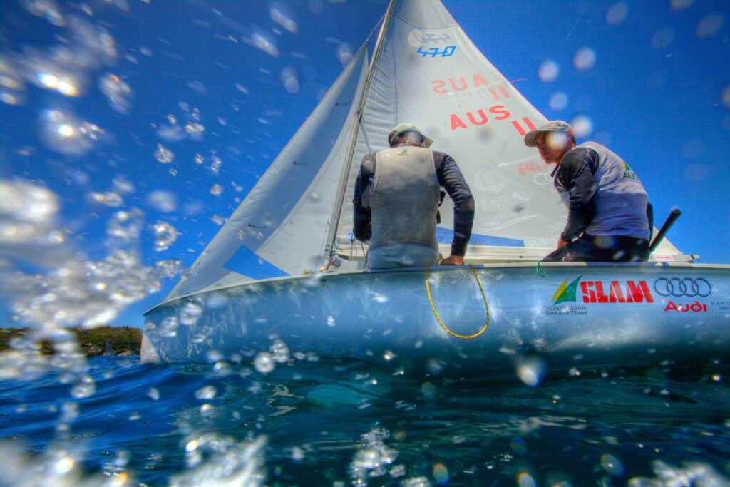 Sailboat race at Woollahra Sailing Club with crew members in action.