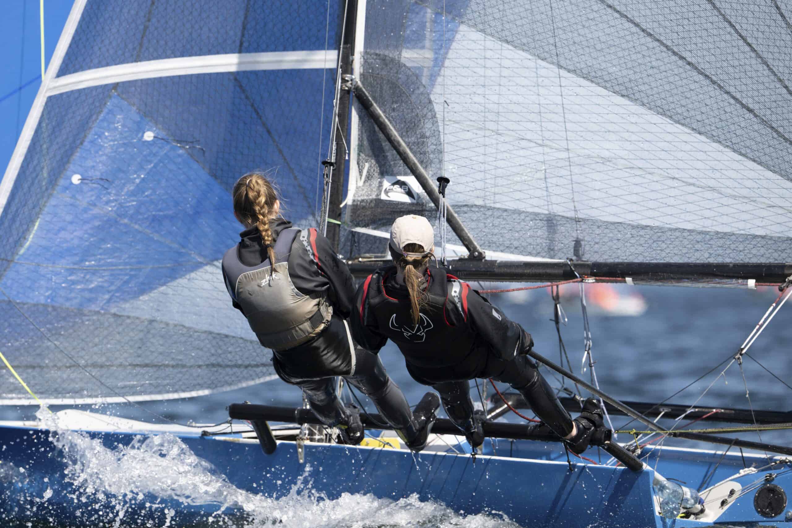 Two sailors racing a yacht at Woollahra Sailing Club.
