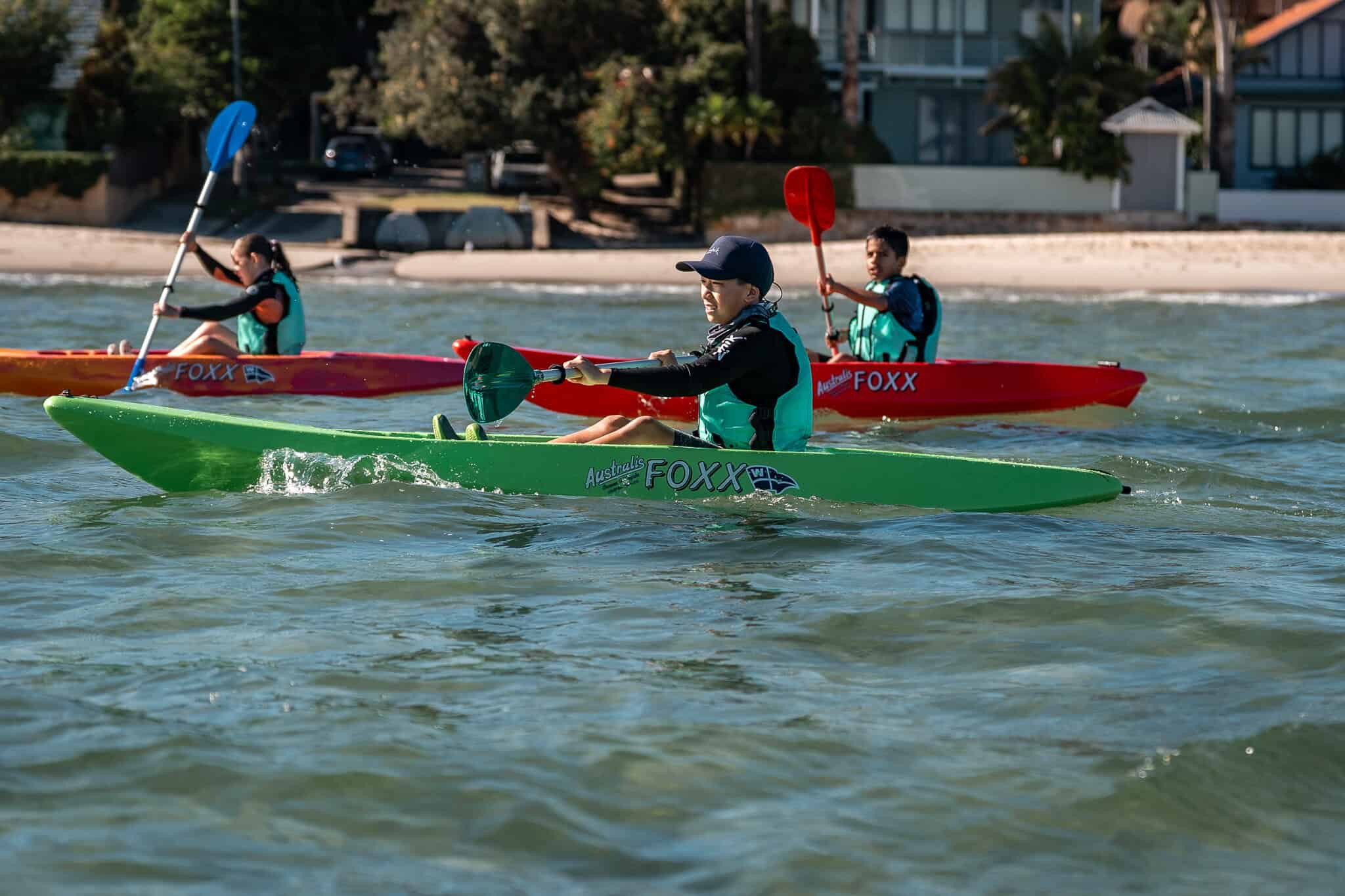 Children kayaking at Woollahra Sailing Club on a sunny day.