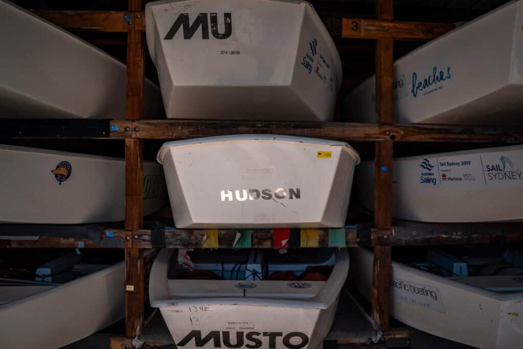Dinghy boats stored on organized racks inside the Woollahra Sailing Club facility