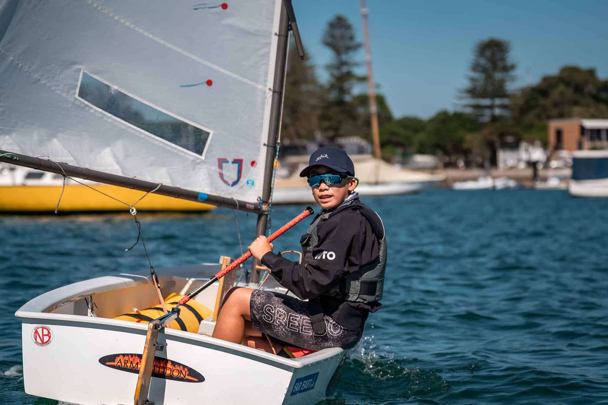 Young sailor in a small boat at Woollahra Sailing Club on a sunny day.