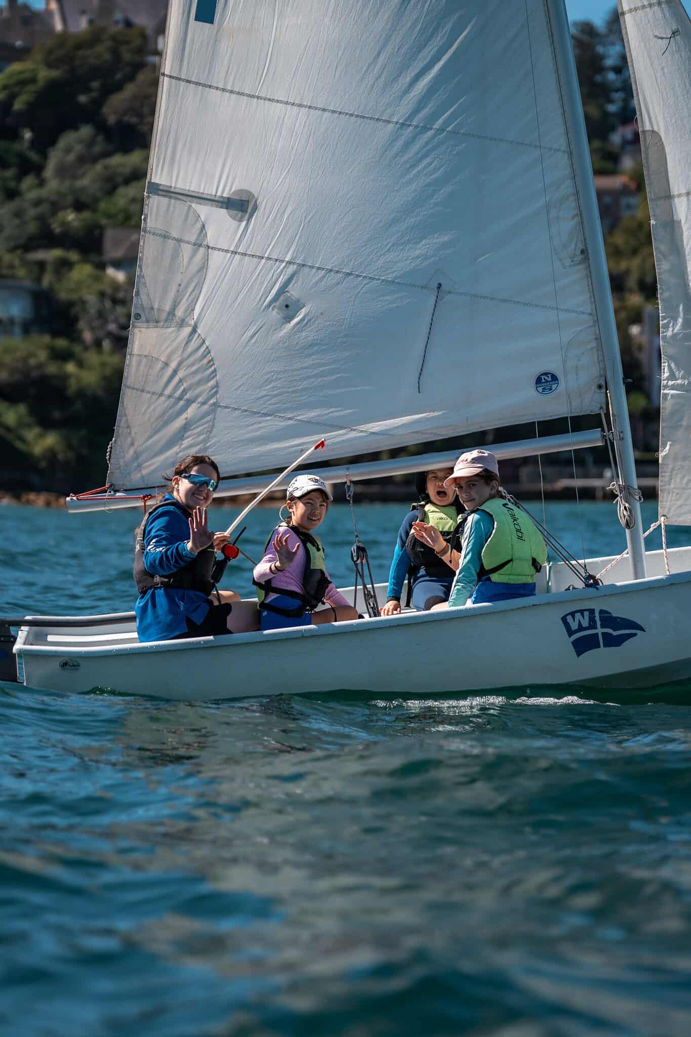Group of young sailors on a small boat at Woollahra Sailing Club.
