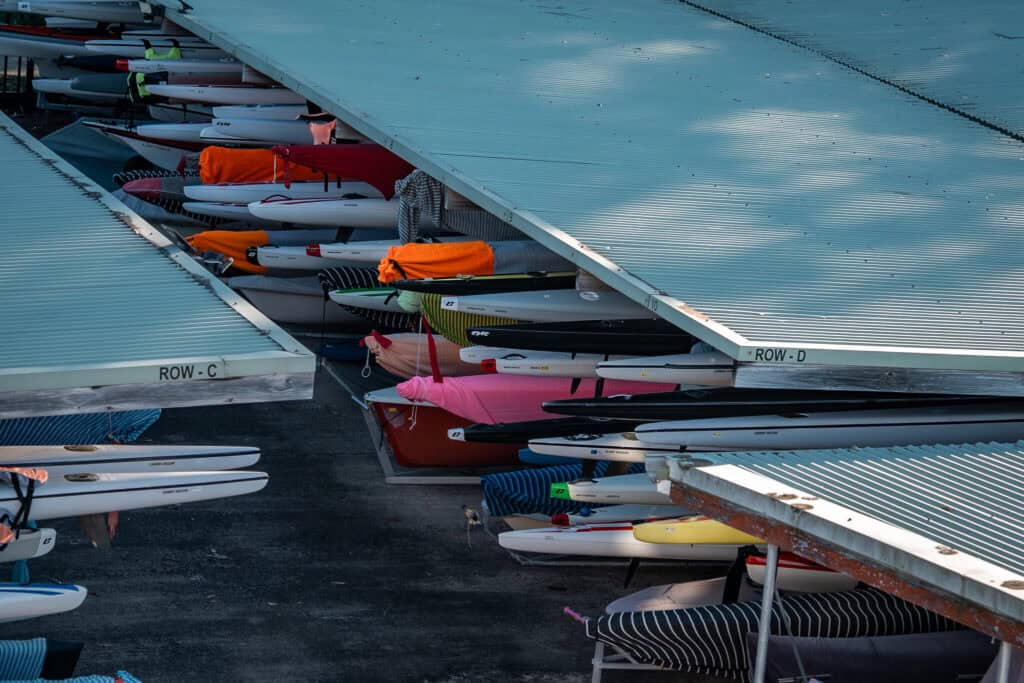 Kayaks and paddles arranged in secure club storage