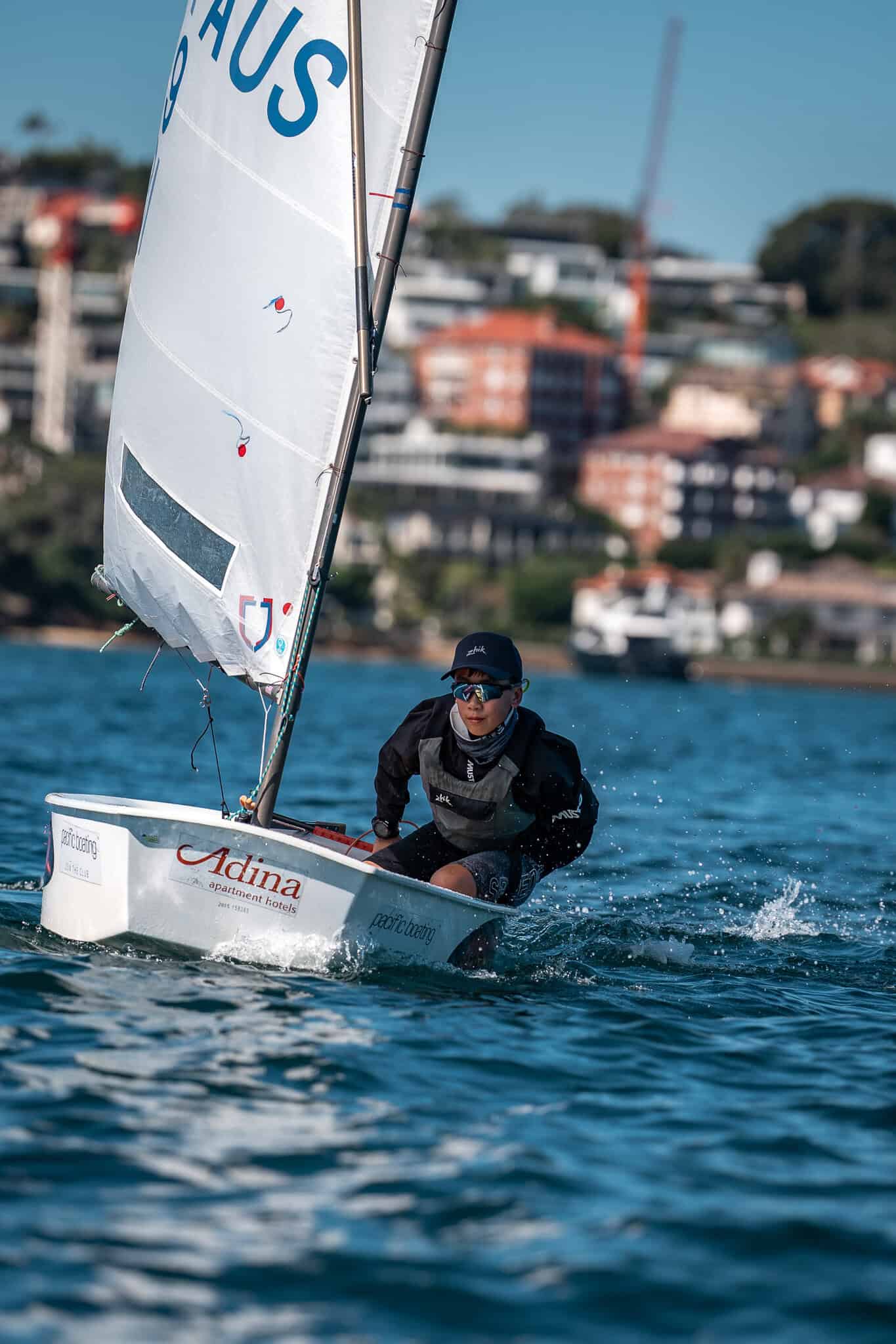 Young sailor in a small boat on water at Woollahra Sailing Club.