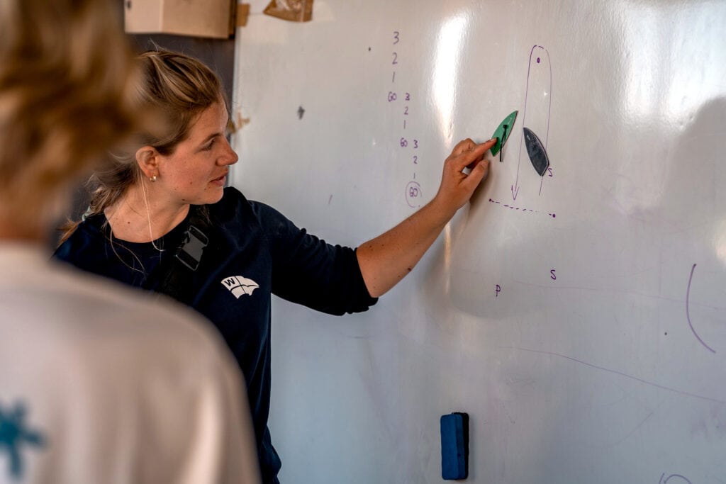 Sailing instructor explaining boat navigation at Woollahra Sailing Club.