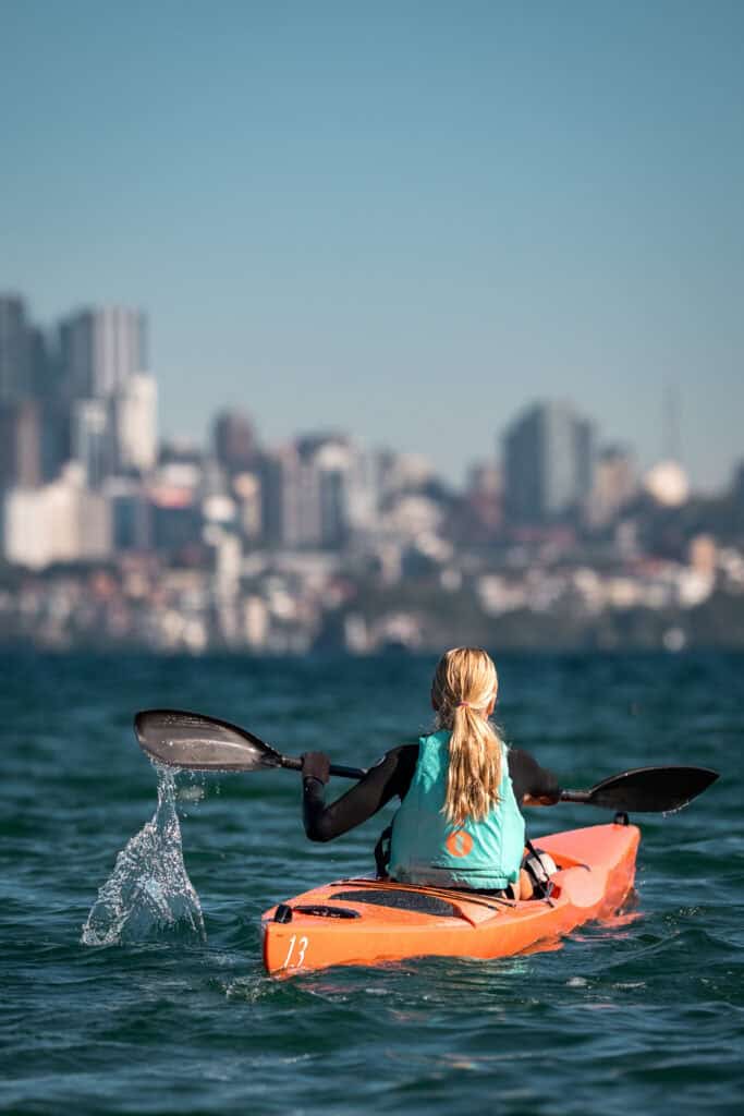 Surf ski paddler launching into Rose Bay